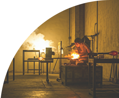 Artisan working in a glass blowing studio